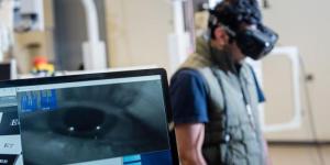 person standing behind a screen with AR/VR headset