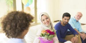 Ethnically diverse group of four people sitting on a couch and interacting